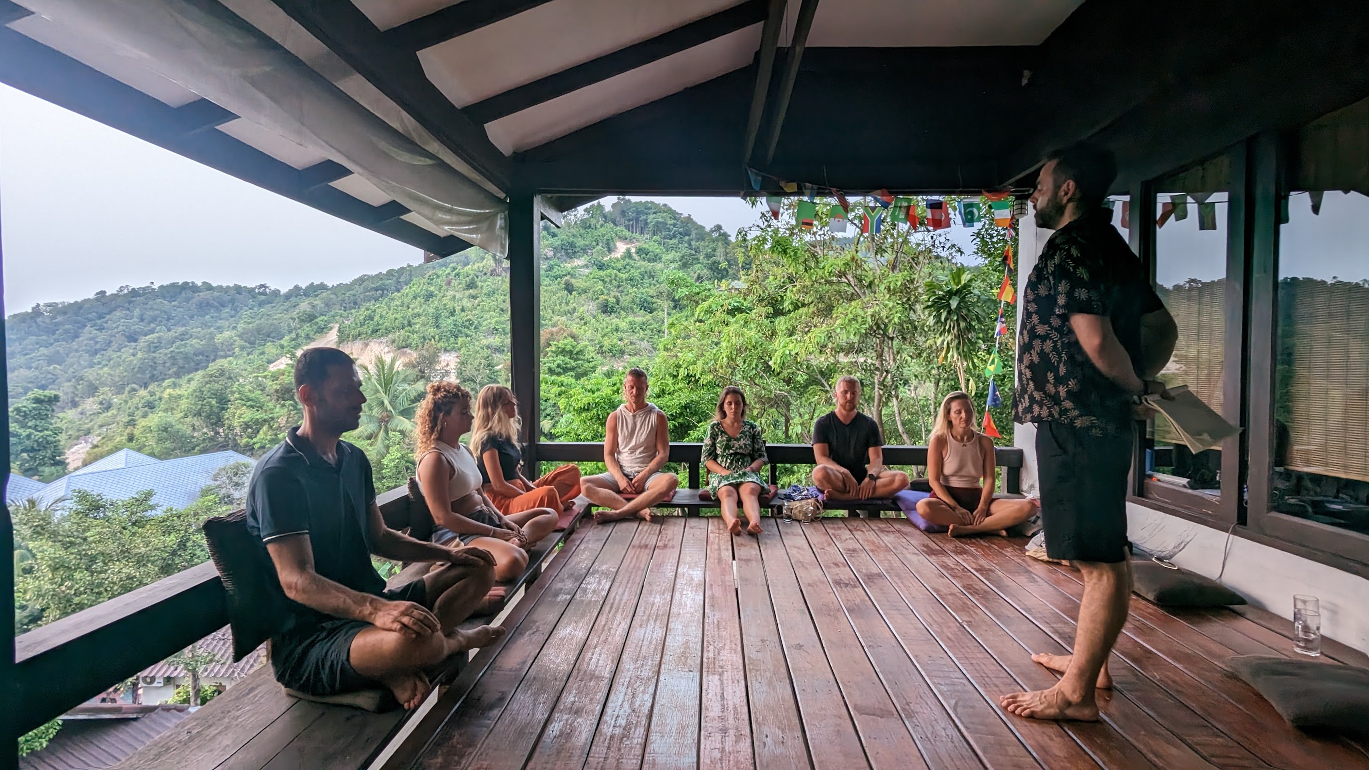 Barak guiding a live hypnosis session with a small group sitting upright around him.